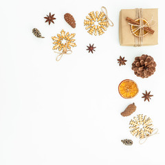 Christmas or New Year composition of wooden decoration, gift box and pine cones on white background. Flat lay, top view