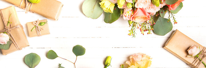 Flowers composition. Flowers and gifts on white background. Flat lay, top view.
