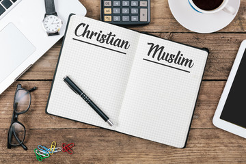 Christan and Muslim on note book at office desktop