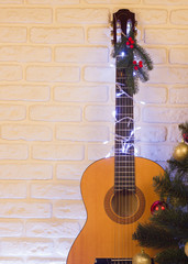 Country music christmas background with guitar on brick wall