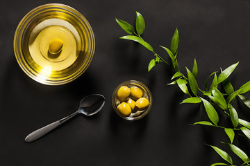 Olive oil and olive branch on the wooden table