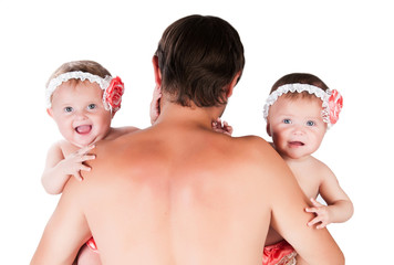 Dad with two daughters in arms, twins