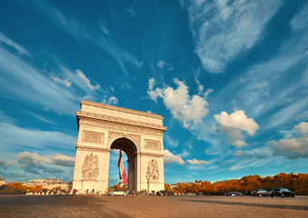 Fototapeta na wymiar Arc de Triumph in Paris with beautiful clouds behind in Fall