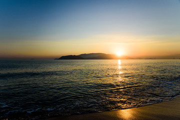 Fototapeta premium Colorful sunrise over sea and the beach with clear skies in Vietnam