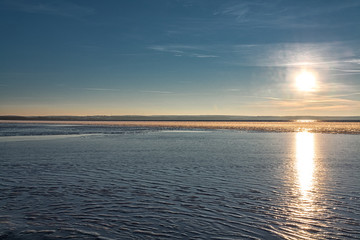 reflection of the evening sun from the first ice on a cold decline at the beginning of winter