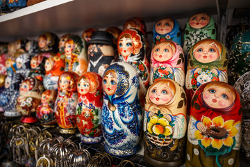 Group of Russian souvenir Matryoshka on store shelf - wooden toy in the form of a painted doll