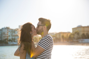 Fototapeta premium Young couple kissing at the seaside