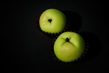 closeup two green apples shaped candy made from marzipan