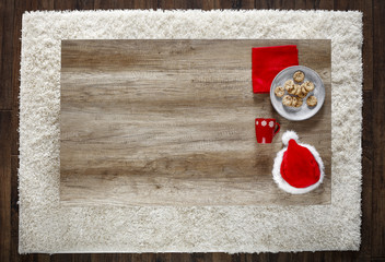 Photo of carpet above the floor. Free space for your decoration. Red santa claus hat.