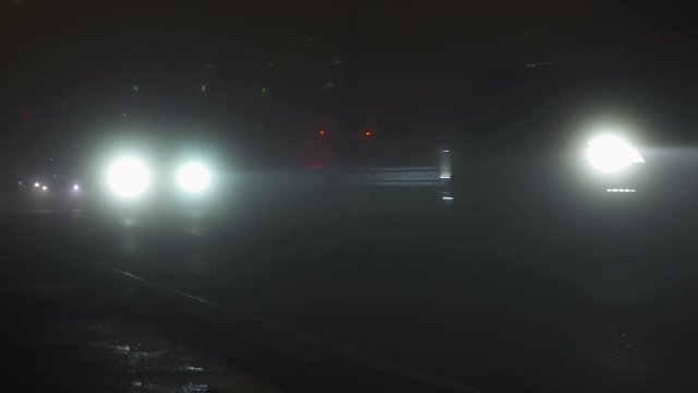 A traffic at fogy evening in winter in Prague.Night City Traffic In The Fog