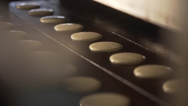 The cookie moves along the conveyor. Cookies on the conveyor
