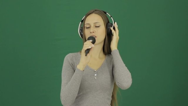 Young cute girl with microphone, chromakey  