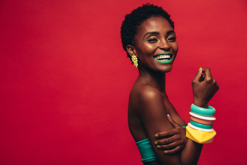 Smiling female model with artistic makeup