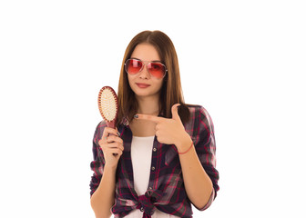 Young cute girl with hairbrush, isolated  