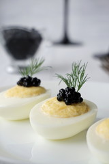 Stuffed eggs with caviar, cheese and mayonnaise