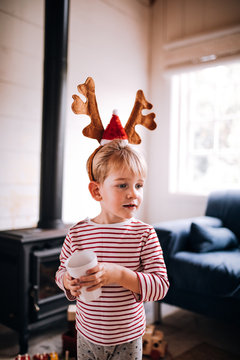 Boy wearing Christmas reindeer antlers
