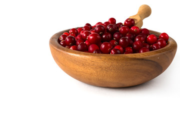 Berries of a cranberry in a wooden bowl on a white background isolate close-up