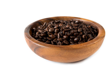 Coffee beans close-up in a wooden bowl of isolate on a white background
