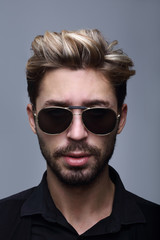 Obraz premium Close-up portrait of handsome stylish man in sunglasses.