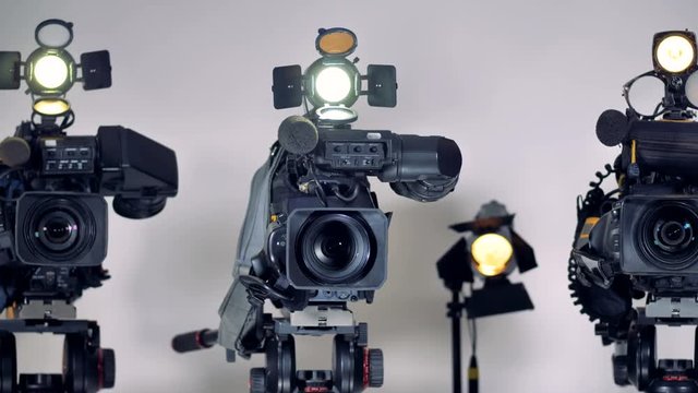 A close view on video cameras lenses and mikes. 
