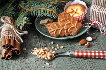 Amond cookies and lemon mini-muffin with ingredients and Christmas tree twigs