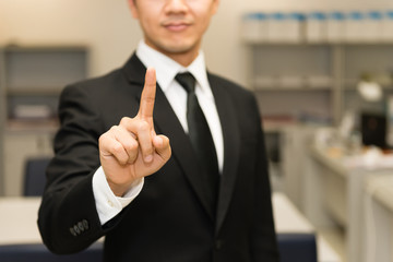 Finger of asian business man in black suit