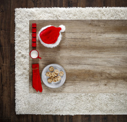 Photo of carpet above the floor. Free space for your decoration. Red santa claus hat.