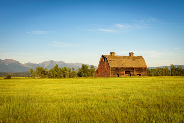 Summer sunset with an old barn in rural Montana