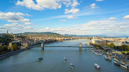 Fototapeta premium Aerial footage from a drone shows the historical Buda Castle near the Danube on Castle Hill in Budapest, Hungary. Bridge on the river. Aerial view.