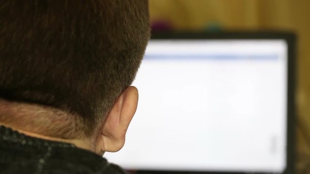 man surfing the Internet. back view