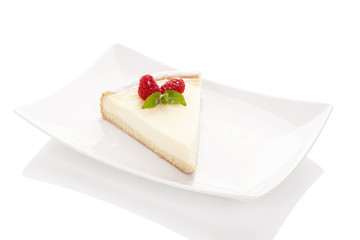 Homemade Cheesecake on white plate.