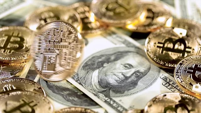 Gold Bit Coin BTC coins and dollar bills.