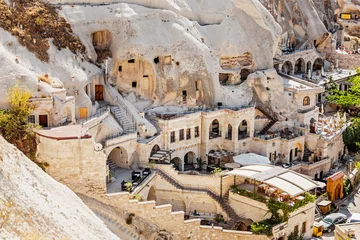 Foto op Canvas Cappadocië hotels uitgehouwen uit stenen rotsen, grotstijl © EdNurg