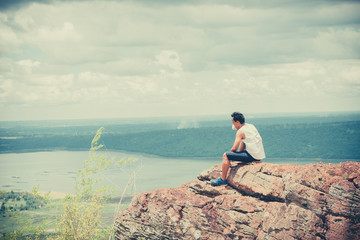 Asian handsome man sit alone on the mountain vintage style