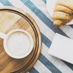 Cappuccino on a striped tablecloth. Morning coffee.