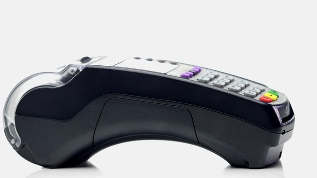 Credit card payment terminal, swiping for sale transaction. Close-up view.
