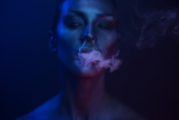 Vape Party, Nightlife. Beautiful Sexy Woman smoking