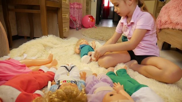 Pretty girl plays with a doll at home. Doll listening. Play one at home.