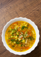 Fish soup with potato and rice on a wooden background. with copy space. top view