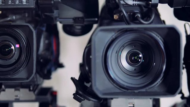 Colorful light spots on three camera lenses. 