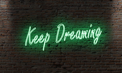 neon letter sign with the quote keep dreaming on a brick wall in the dark