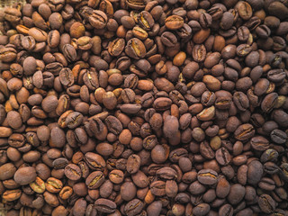 Coffee beans on burlap background.
