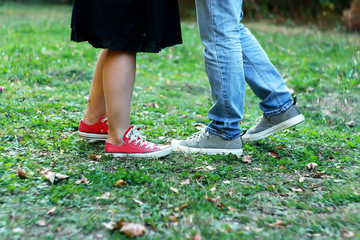  man and woman in sneakers standing on the grass
