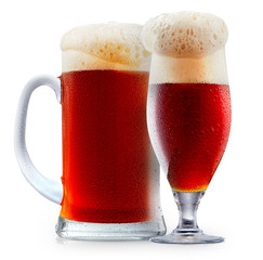 Mug of frosty dark red beer with foam isolated on a white background