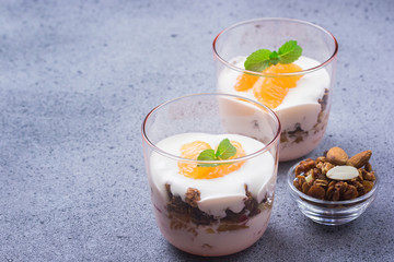 Orange juice granola dessert on concrete background. Selective focus, cpace for text. 