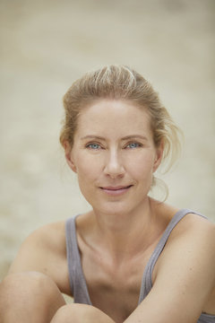 Portrait of smiling blond woman on the beach