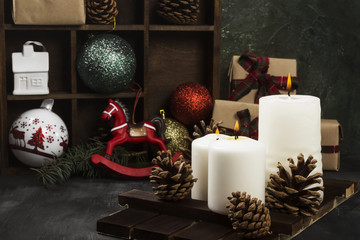 Burning candles and Christmas attributes on a dark background