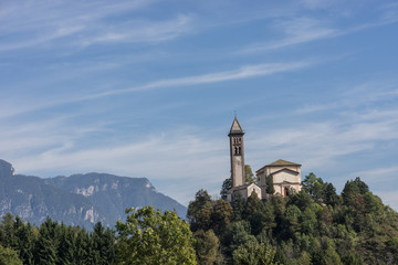 Castle on the hill landscape, mountains and peaks in background. Trentino South Tirol Castello Molina Di Fiemme, Alto Adige, Italy - Saint George Church