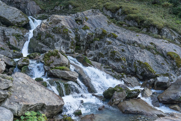 Naklejka na ściany i meble Mountain river and stones landscape natural environment. Hiking in the alps. Grawa Waterfall in Stubai Valley, Tyrol, Austria