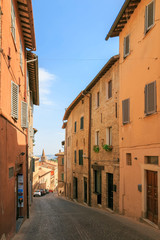 Urbino, Italy - August 9, 2017: A small street in the old town of Urbino. sunny day.